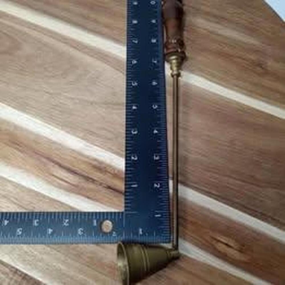 Brass candle snuffer with a dark wood handle.